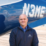 pilot standing in front of business jet